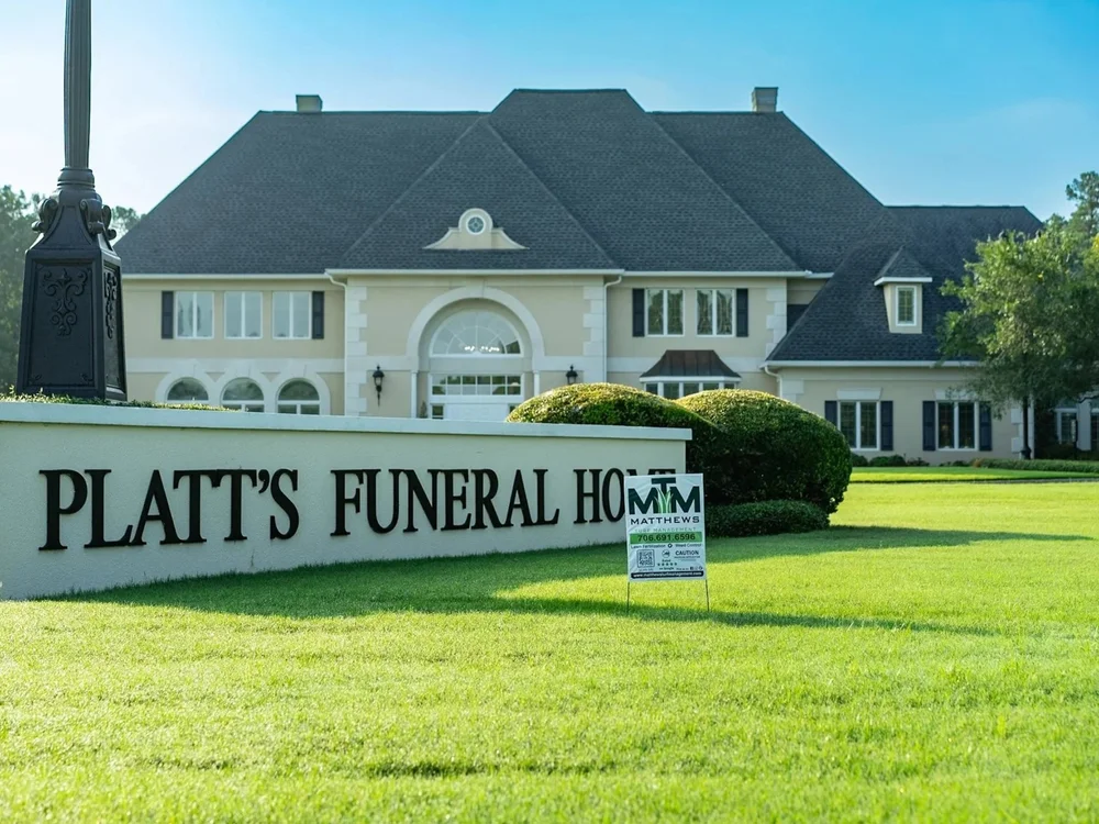 Matthews Turf Management yard sign on a well-maintained commercial property lawn
