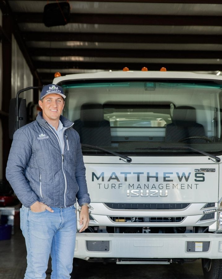 Matthews Turf Management team member beside company truck