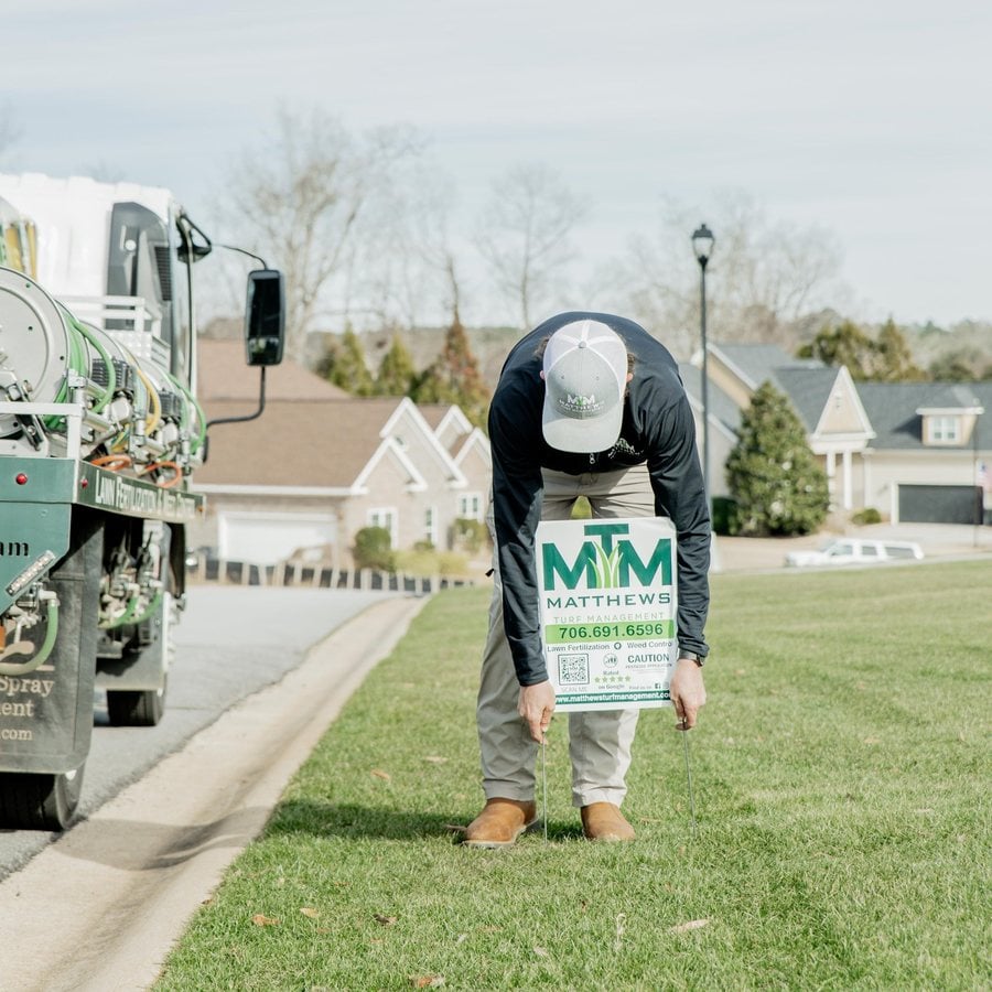 Matthews Turf Management technician treating a residential lawn
