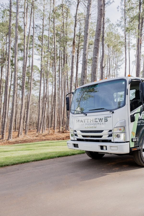 Matthews Turf Management service truck in a neighborhood