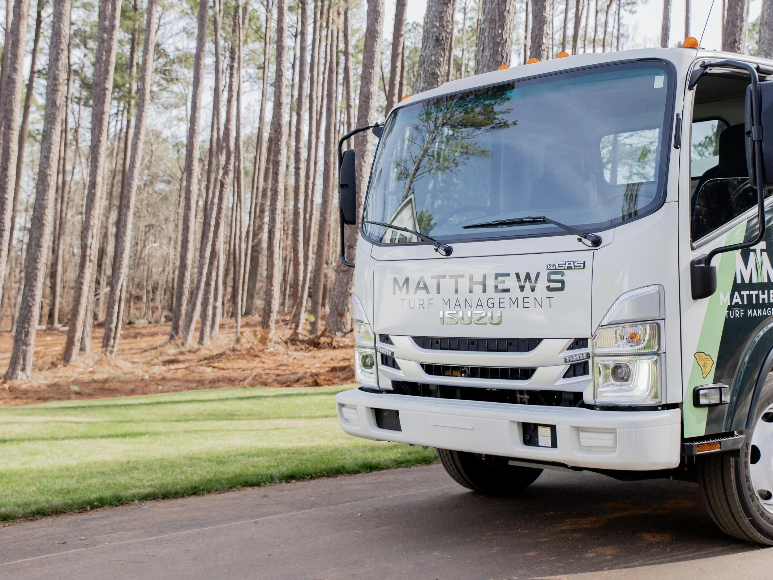 Matthews Turf Management service truck in a local neighborhood