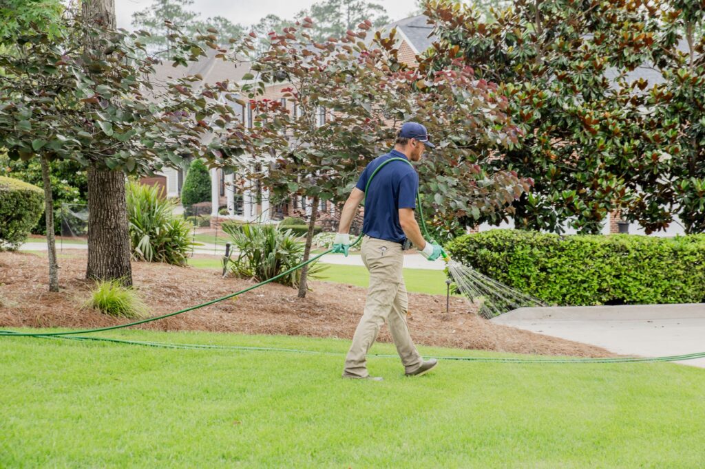 Matthews Turf Management technician applying a lawn treatment in Augusta, GA