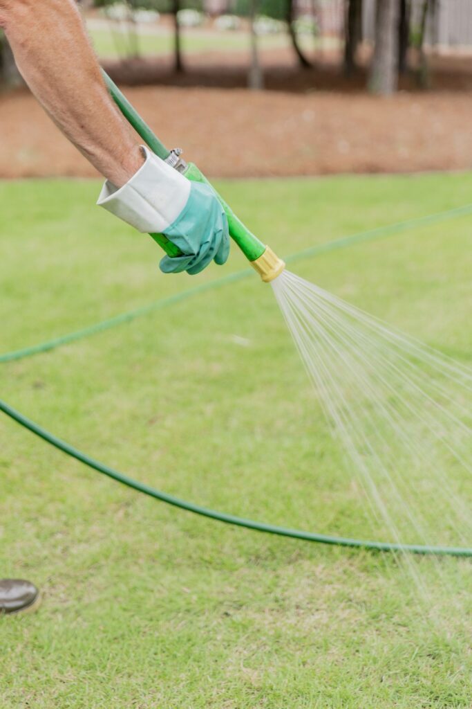 Close-up of a liquid lawn treatment being sprayed on turf